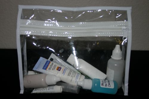 Minimized toiletries in a zippered toiletry bag.
