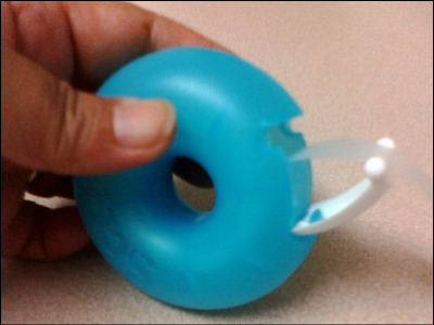 The white tab acts as the dispensing portion of the donut.